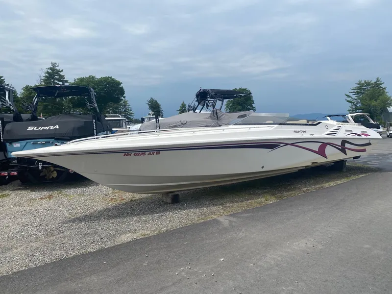 Slide: The Image of 1998 Fountain 35 Lightning speedboat on a trailer in a marina. - 3