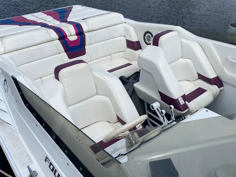 Slide: The Image of 1998 Fountain 35 Lightning boat interior with white and maroon seats. - 4