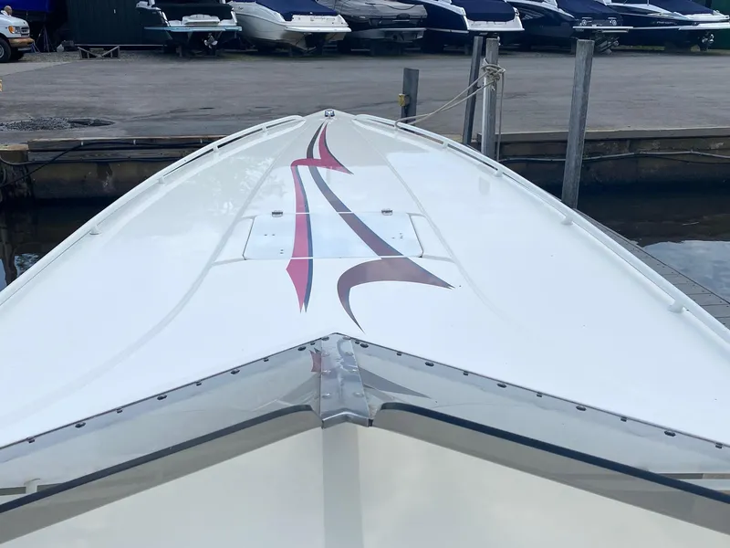 Slide: The Image of 1998 Fountain 35 Lightning boat docked, showcasing sleek design and vibrant graphics. - 6