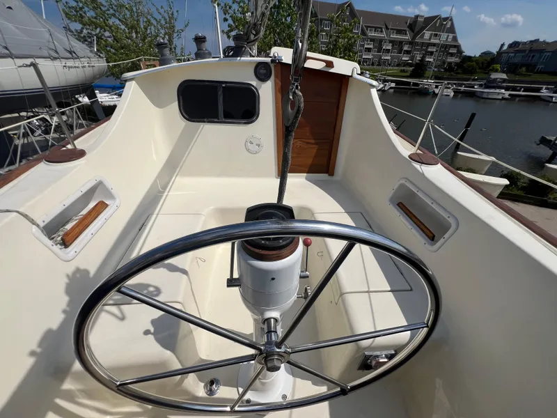 Slide: The Image of 1982 Campion C-320 Pilot House boat cockpit with steering wheel, docked at marina. - 16