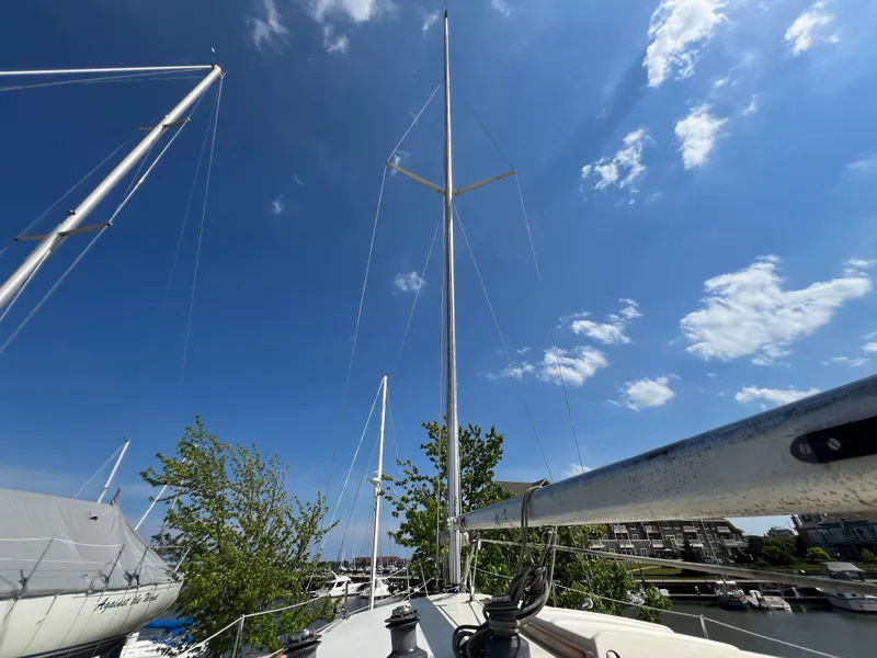 Slide: The Image of 1982 Campion C-320 Pilot House sailboat docked under a clear blue sky. - 19
