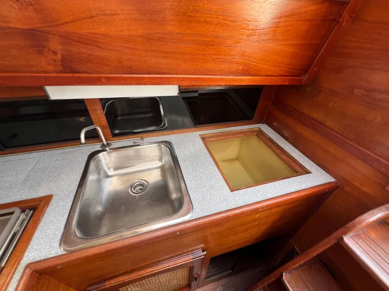 Slide: The Image of 1982 Campion C-320 Pilot House kitchen with stainless steel sink and wooden cabinetry. - 25