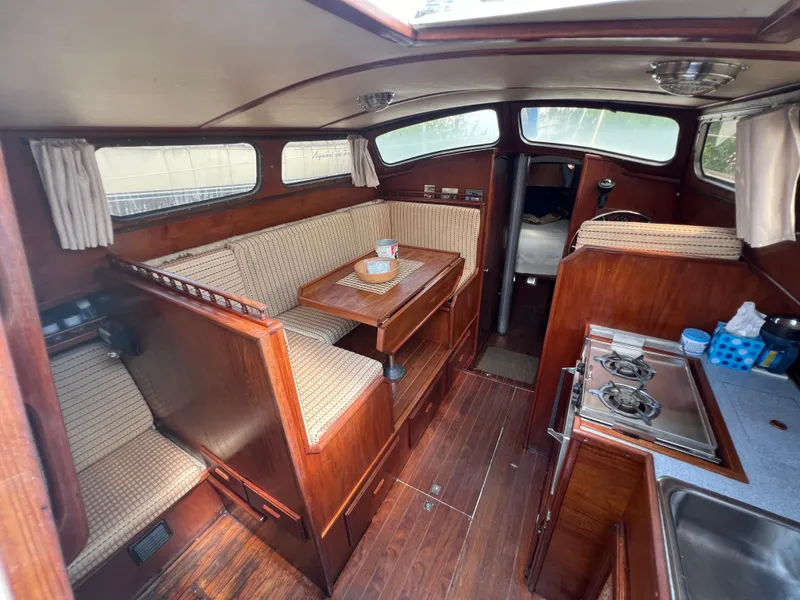 Slide: The Image of Interior of 1982 Campion C-320 Pilot House with dining area, kitchen, and wooden finishes. - 26