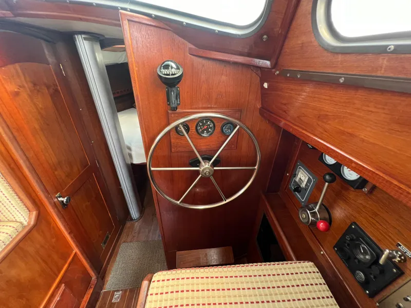 Slide: The Image of 1982 Campion C-320 Pilot House interior with wooden helm and navigation instruments. - 31