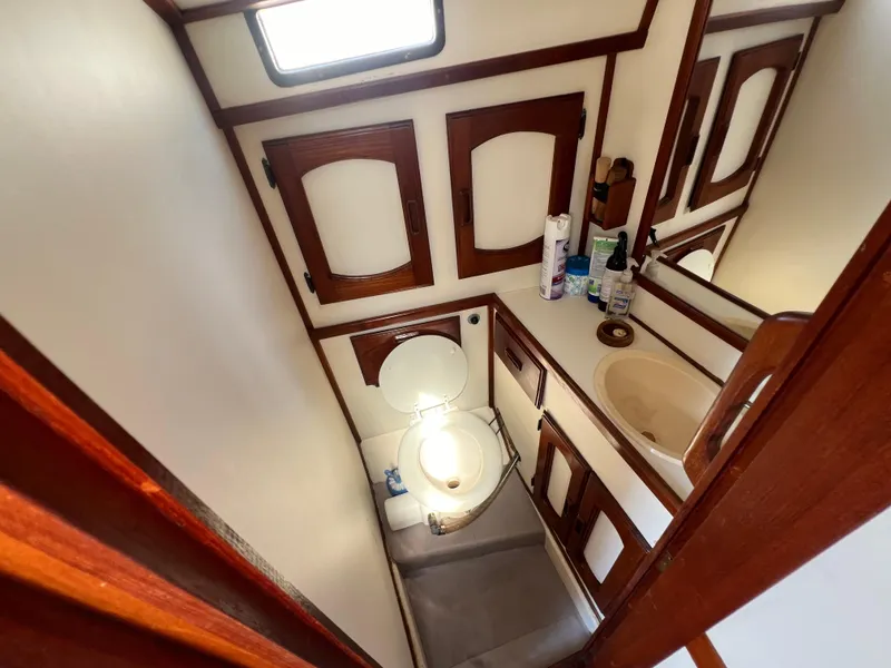 Slide: The Image of 1982 Campion C-320 Pilot House bathroom with wooden cabinets and a small sink. - 38
