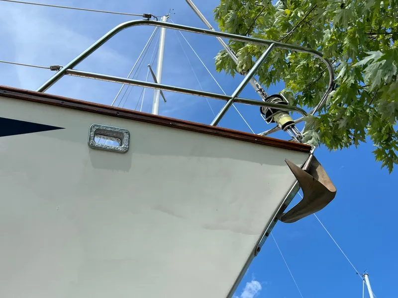 Slide: The Image of 1982 Campion C-320 Pilot House boat bow with anchor against blue sky. - 4