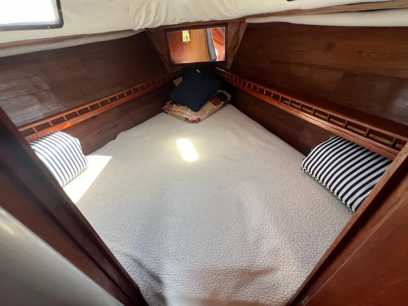 Slide: The Image of Cozy cabin interior of 1982 Campion C-320 Pilot House with wooden walls and bedding. - 40
