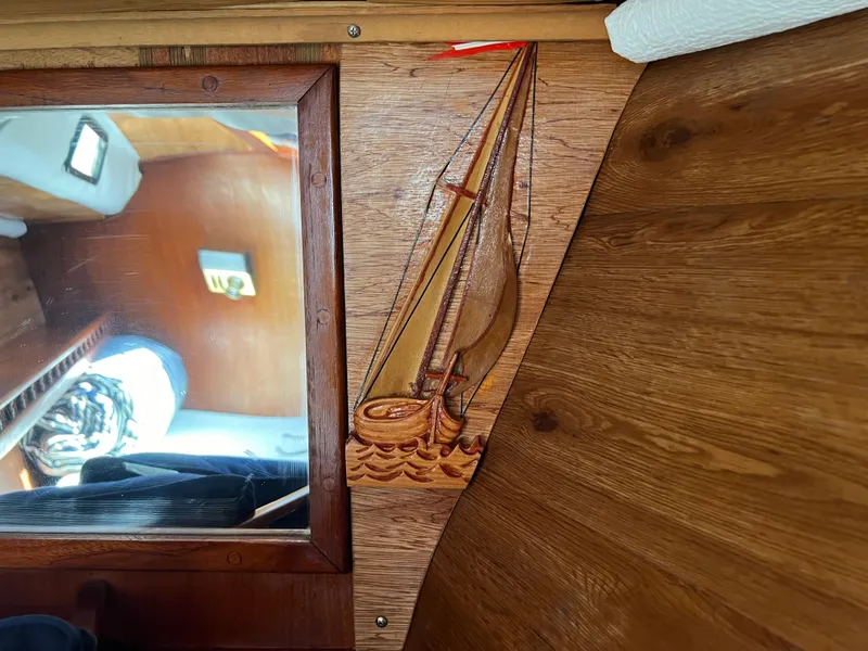 Slide: The Image of Wooden interior of 1982 Campion C-320 Pilot House with sailboat carving. - 43