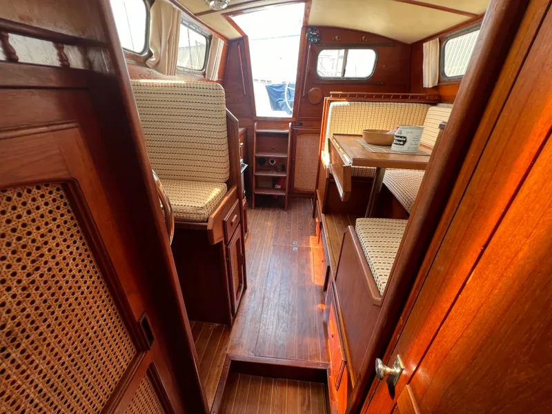 Slide: The Image of 1982 Campion C-320 Pilot House interior with wooden furnishings and woven seats. - 45