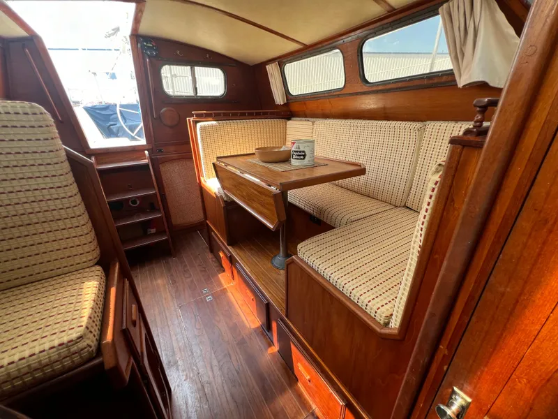 Slide: The Image of 1982 Campion C-320 Pilot House interior with wooden furnishings and cushioned seating. - 46