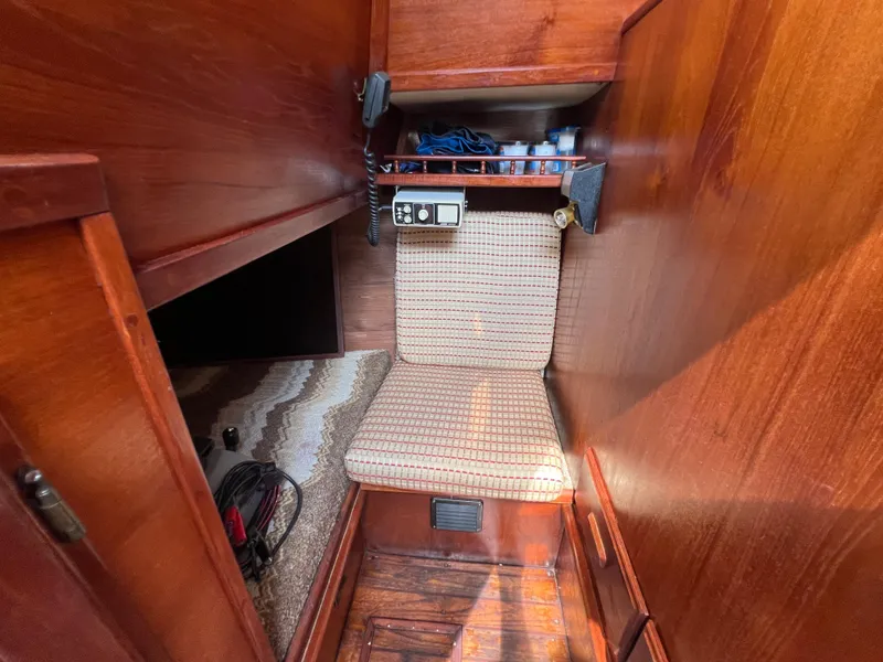 Slide: The Image of Interior of 1982 Campion C-320 Pilot House with wooden paneling and cushioned seat. - 49