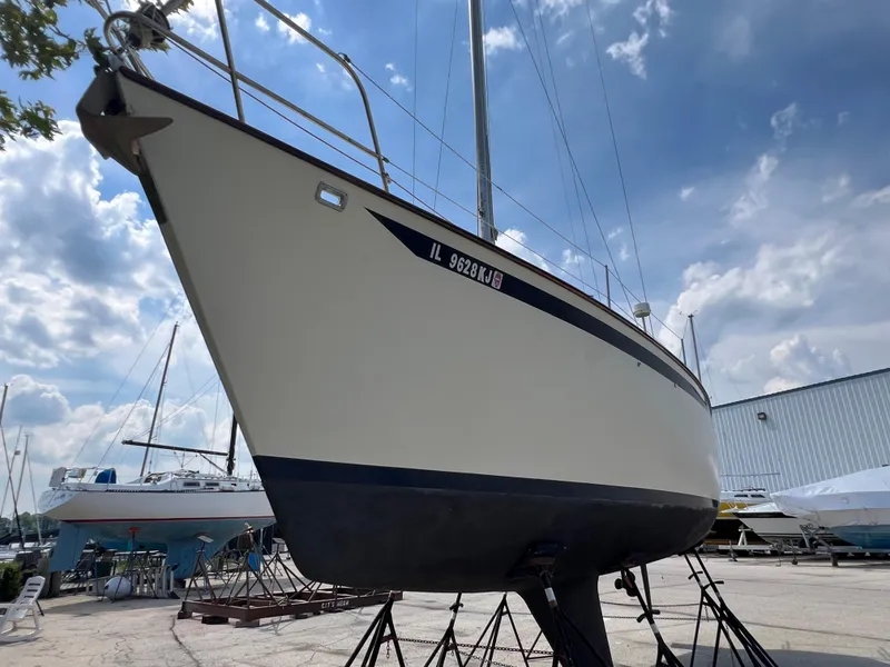 Slide: The Image of 1982 Campion C-320 Pilot House sailboat on stands in a boatyard. - 6
