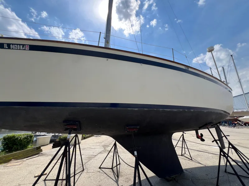 Slide: The Image of 1982 Campion C-320 Pilot House sailboat on stands under a clear sky. - 7