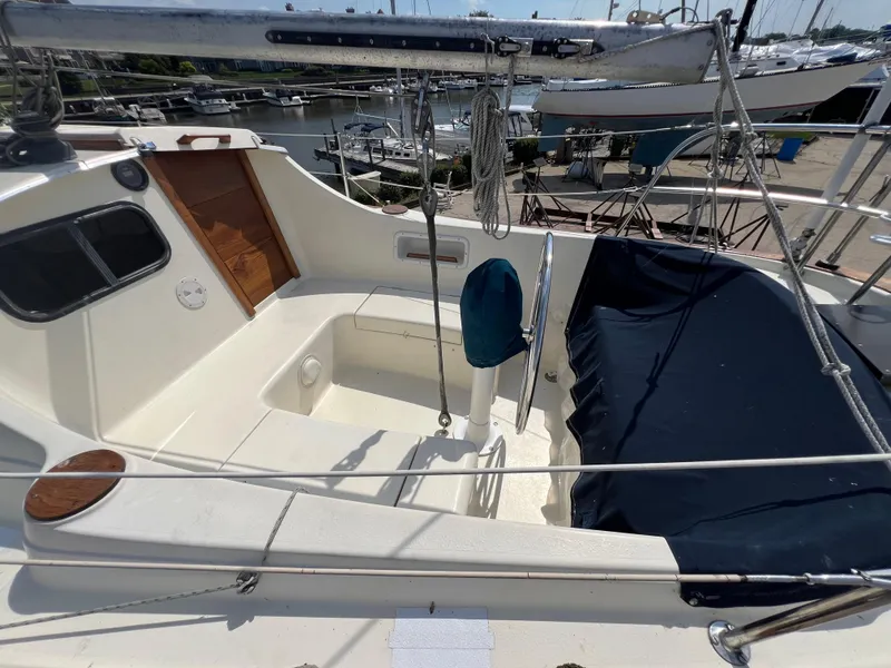 Slide: The Image of 1982 Campion C-320 Pilot House boat cockpit with covered seating and wooden door. - 9