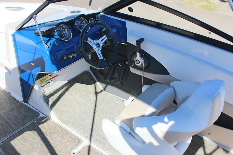 Slide: The Image of 2018 Glastron GT200 boat cockpit with steering wheel and control panel. - 12