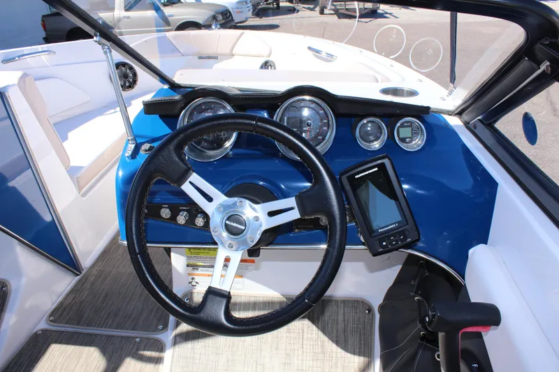 Slide: The Image of 2018 Glastron GT200 boat dashboard with steering wheel and navigation system. - 13