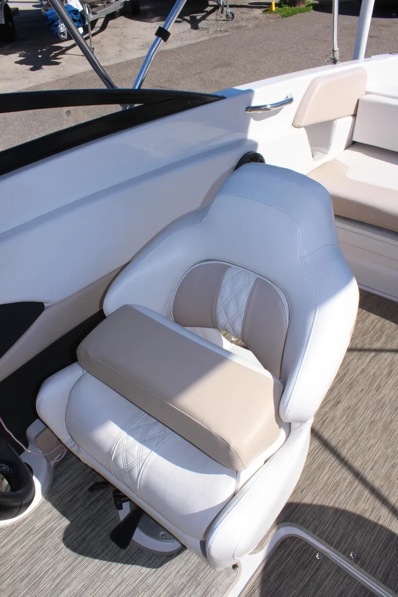 Slide: The Image of 2018 Glastron GT200 boat interior with white and beige captain's chair. - 14