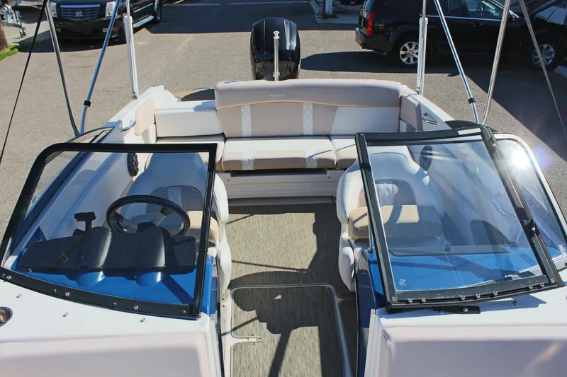 Slide: The Image of 2018 Glastron GT200 boat interior with seating and steering wheel. - 23