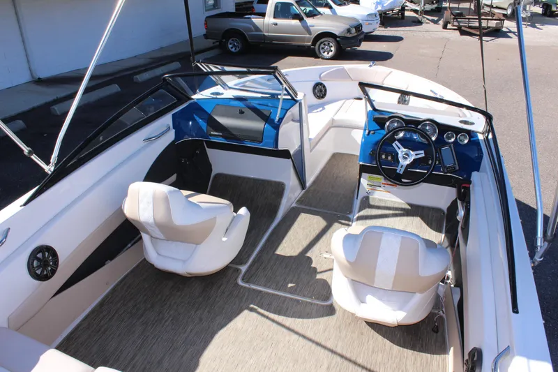 Slide: The Image of 2018 Glastron GT200 boat interior with beige seats and blue dashboard. - 25