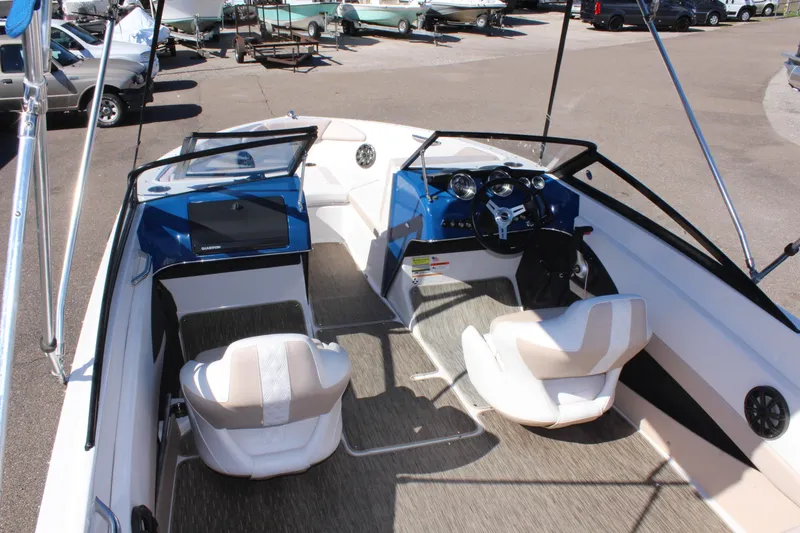Slide: The Image of 2018 Glastron GT200 boat interior with white and beige seating, dashboard, and steering wheel. - 26