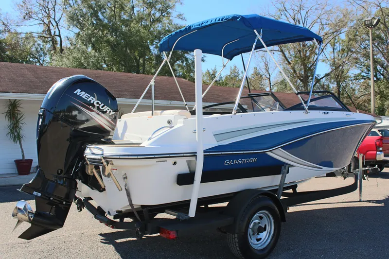 Slide: The Image of 2018 Glastron GT200 boat with Mercury outboard motor and blue canopy. - 5