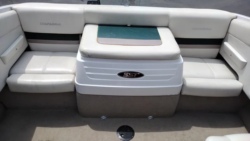 Slide: The Image of 1996 Chaparral 2330 SS boat interior with white cushioned seating. - 10