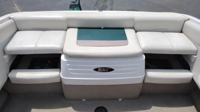 Slide: The Image of 1996 Chaparral 2330 SS boat interior with white cushioned seating. - 16