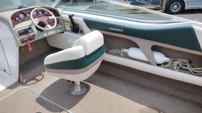 Slide: The Image of 1996 Chaparral 2330 SS boat interior with steering wheel and seating. - 19