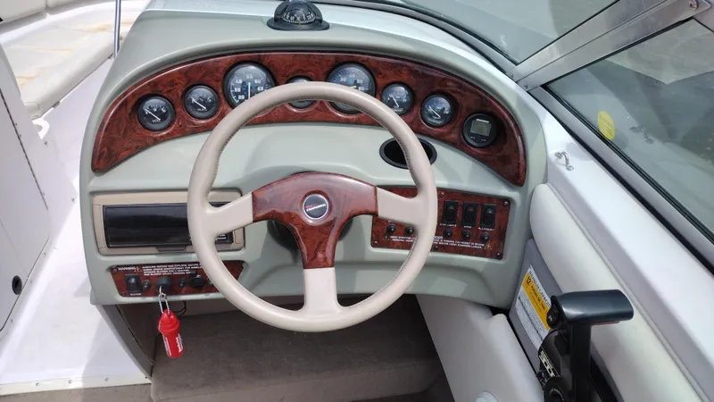 Slide: The Image of 1996 Chaparral 2330 SS boat dashboard with steering wheel and instrument panel. - 7