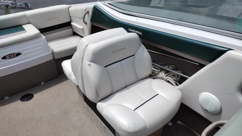 Slide: The Image of 1996 Chaparral 2330 SS boat interior with white leather seats and storage area. - 9