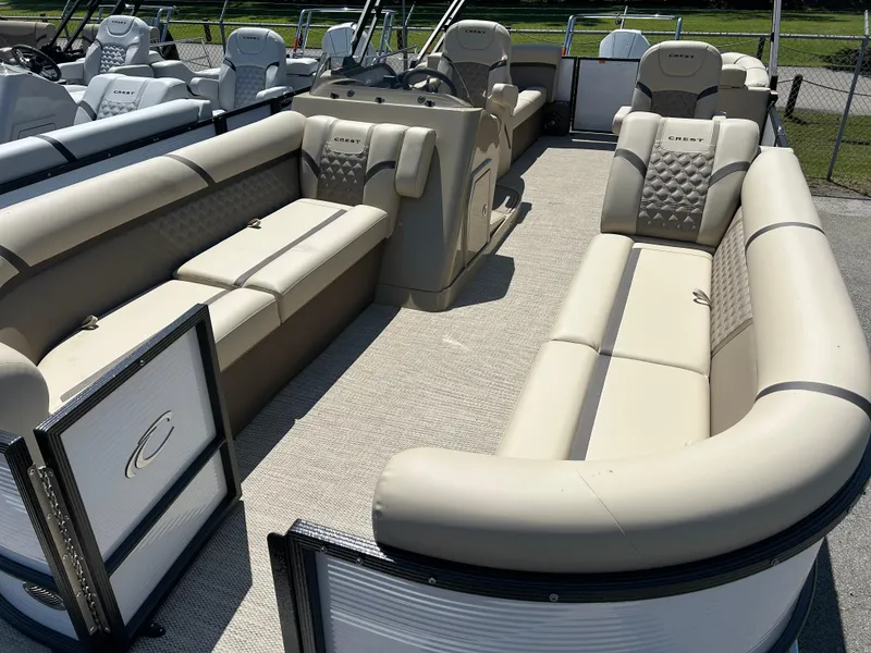 Slide: The Image of 2024 Crest Classic Platinum 240 SLC pontoon boat with luxurious beige seating. - 10