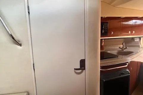 Slide: The Image of Interior of 2007 Sea Ray 290 Amberjack showing kitchenette and door. - 8