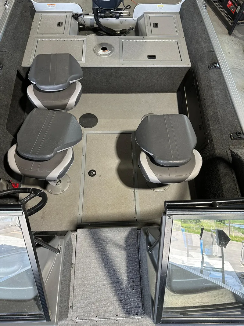 Slide: The Image of 2022 Starcraft Renegade 168 DC boat interior with seating and storage compartments. - 2