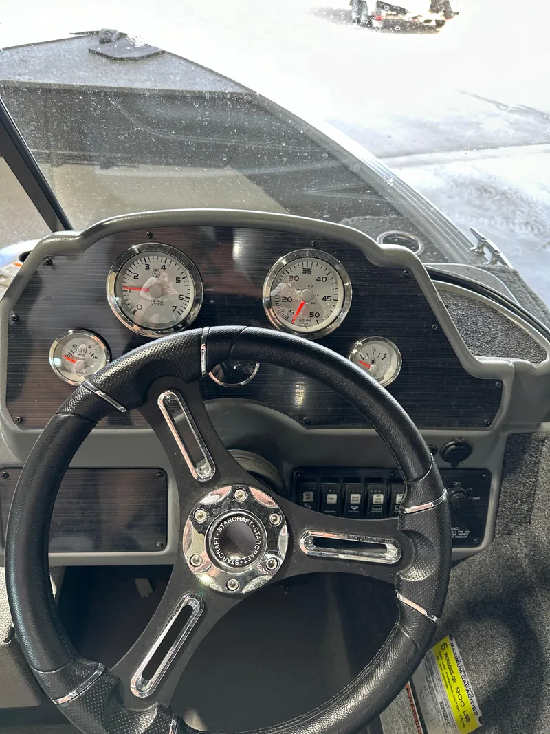 Slide: The Image of 2022 Starcraft Renegade 168 DC dashboard with steering wheel and gauges. - 4