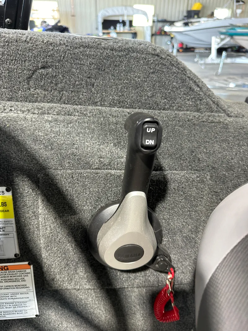 Slide: The Image of 2022 Starcraft Renegade 168 DC boat throttle control lever in a marine setting. - 6