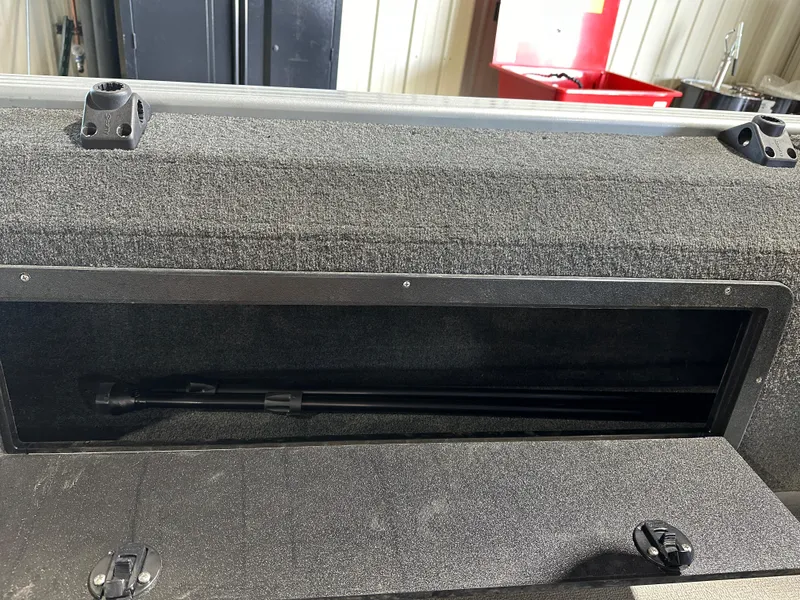 Slide: The Image of 2022 Starcraft Renegade 168 DC storage compartment with black interior. - 8