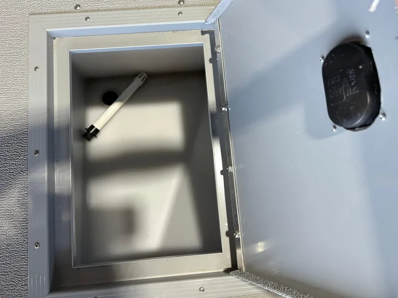 Slide: The Image of 2022 Starcraft Renegade 168 DC storage compartment with a white rod inside. - 9