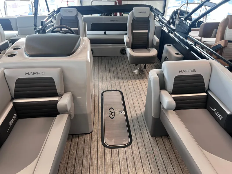 Slide: The Image of 2024 Harris Solstice 230 boat interior with gray and black seating. - 12