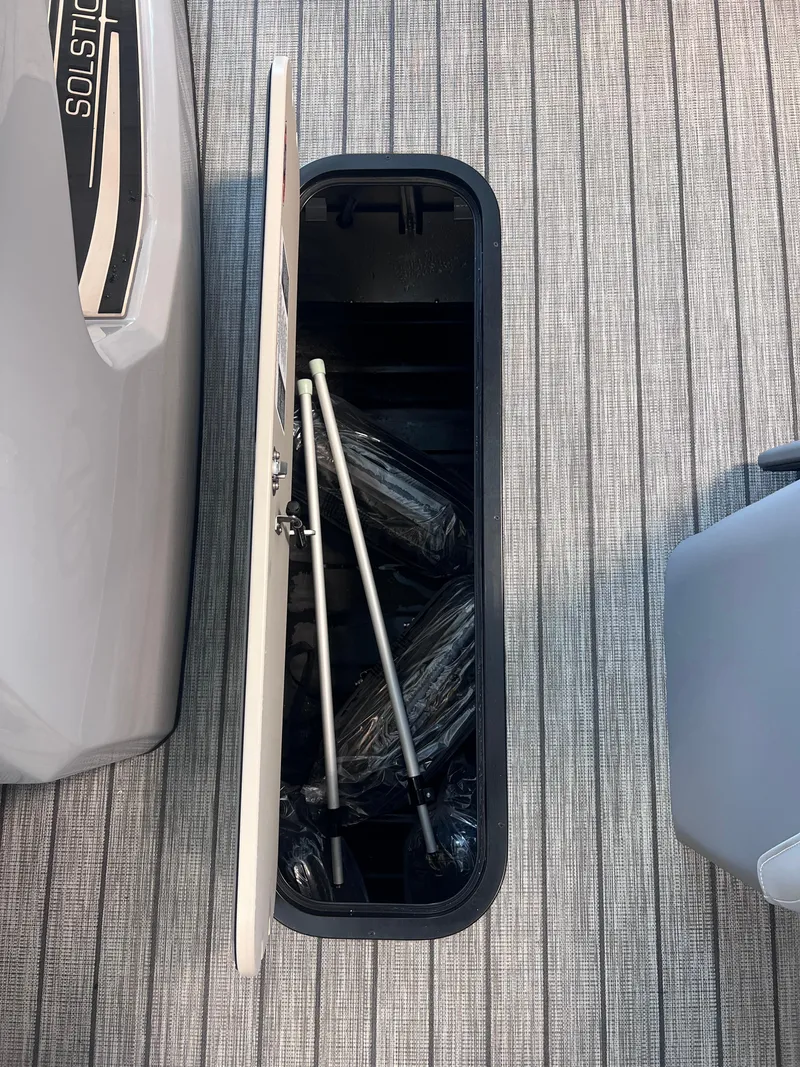 Slide: The Image of 2024 Harris Solstice 230 storage compartment with accessories. - 16