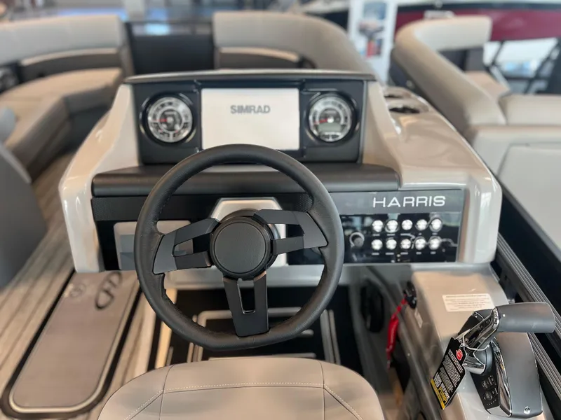 Slide: The Image of 2024 Harris Solstice 230 boat dashboard with steering wheel and control panel. - 18