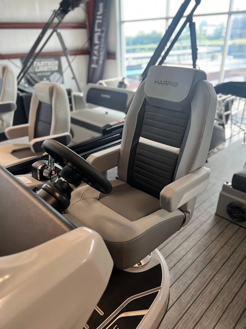 Slide: The Image of 2024 Harris Solstice 230 boat interior with captain's chair and steering wheel. - 20