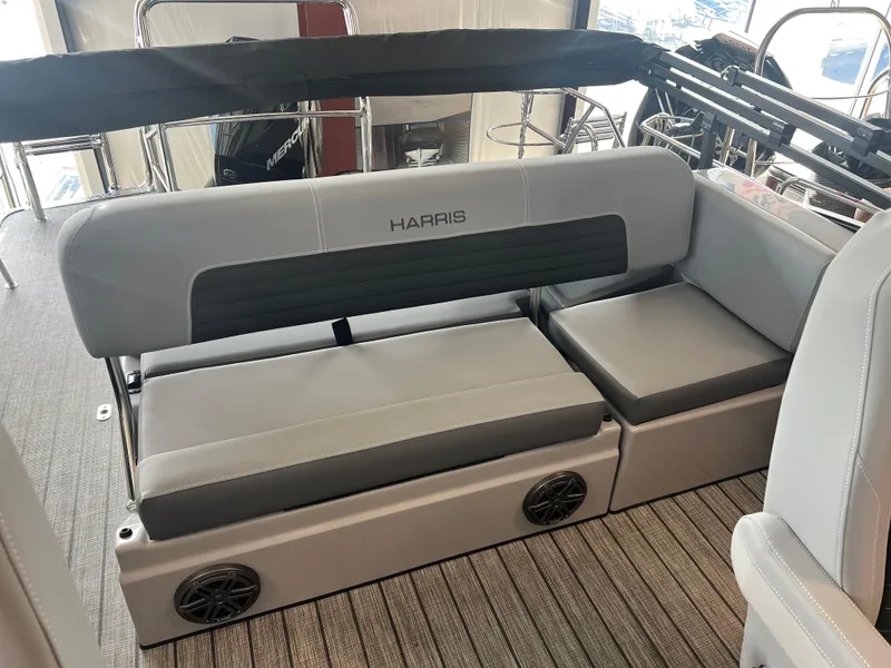 Slide: The Image of 2024 Harris Solstice 230 boat interior with gray seating and speakers. - 22