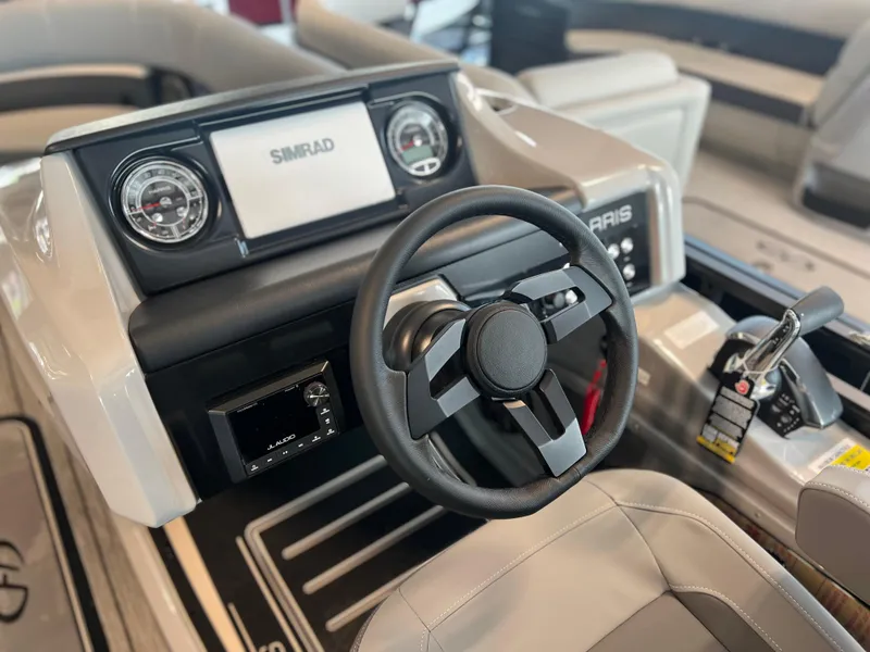 Slide: The Image of 2024 Harris Solstice 230 boat dashboard with steering wheel and control panel. - 23