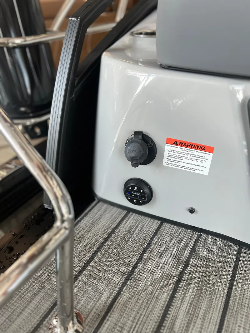 Slide: The Image of 2024 Harris Solstice 230 boat interior detail with warning label and control panel. - 28