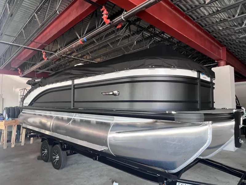Slide: The Image of 2024 Harris Solstice 230 pontoon boat in a showroom. - 3