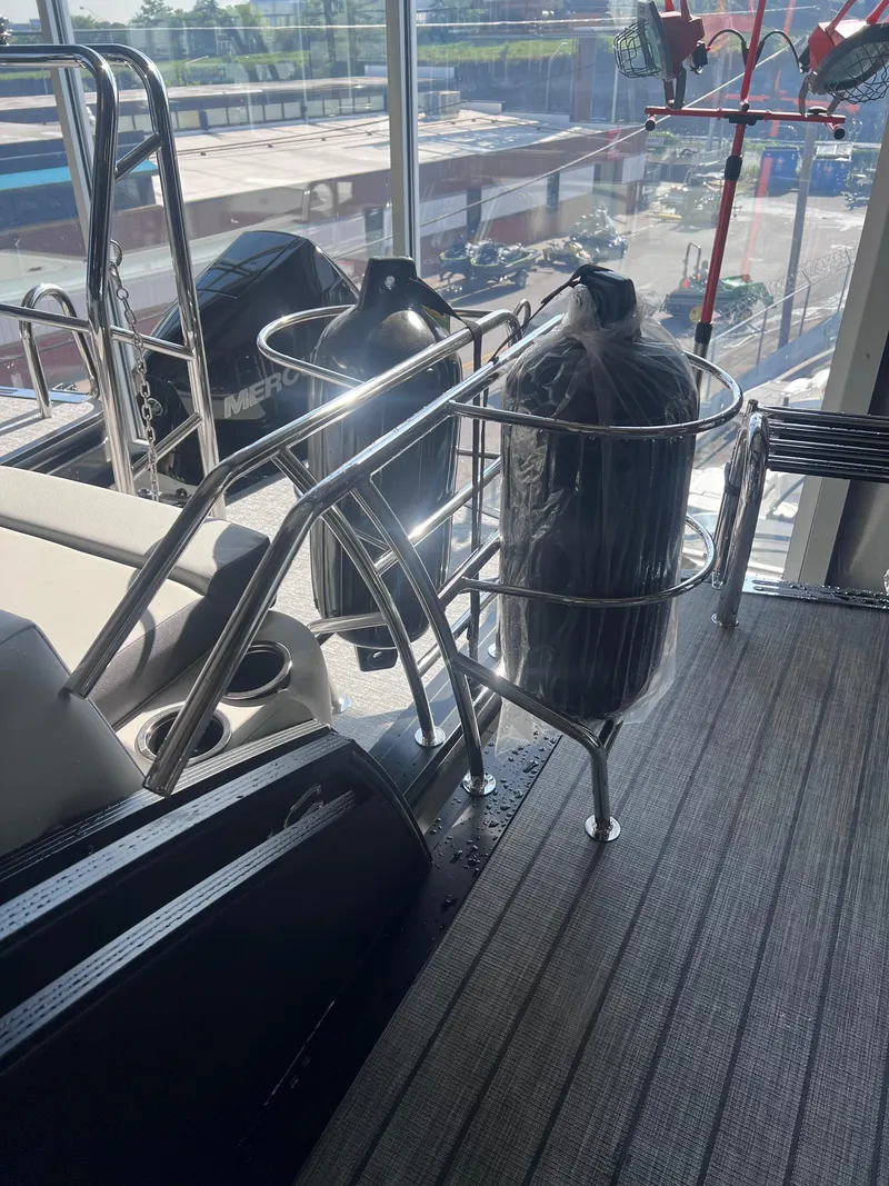 Slide: The Image of 2024 Harris Solstice 230 boat interior with stainless steel railing and Mercury engine. - 31