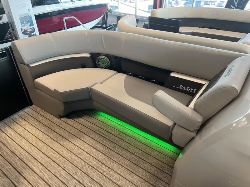 Slide: The Image of 2024 Harris Solstice 230 boat interior with gray seating and green LED lighting. - 33