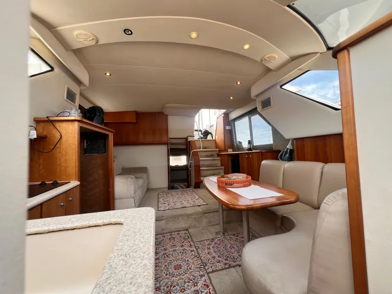 Slide: The Image of Interior of 2001 Silverton 352 Motor Yacht with cozy seating and wooden cabinetry. - 11