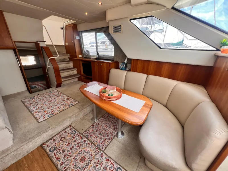 Slide: The Image of Interior of 2001 Silverton 352 Motor Yacht with cozy seating and elegant decor. - 15