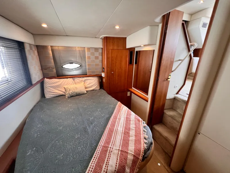 Slide: The Image of Interior cabin of a 2001 Silverton 352 Motor Yacht with bed and stairs. - 20